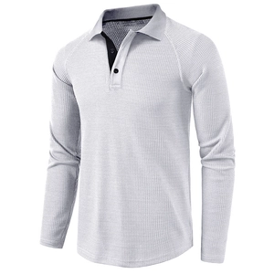 Detail of white waffle knit polo shirt showing grey collar and buttoned placket texture