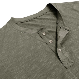 Detail of olive green Henley shirt showing three-button placket and slub cotton texture