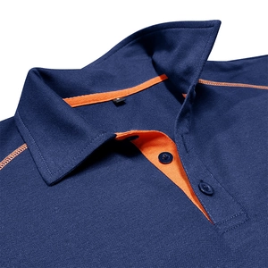 Detail of navy blue pique polo shirt featuring orange contrast stitching and collar lining