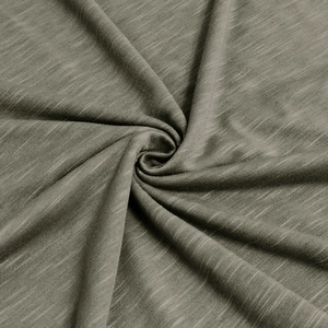 Macro shot of grey-green slub cotton fabric showing detailed texture and natural weave pattern