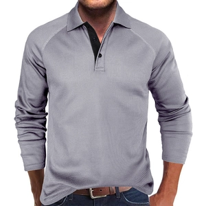 Detail of grey waffle knit polo shirt with contrast collar and dual button placket
