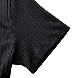 Detail of ribbed fabric cuff on black athletic shirt with double needle stitching