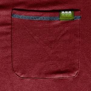 Detail view of burgundy henley shirt featuring a square pocket with navy blue stitching