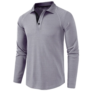 Close-up of waffle knit texture and raglan sleeve detail on a men's long sleeve polo shirt