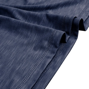 Detailed close-up of dark blue slub cotton fabric with high-quality double stitching