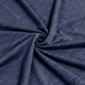 Macro shot of navy blue slub cotton fabric showing detailed texture and soft drape quality