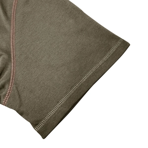 Detail of reinforced flatlock stitching on dark olive green knit cotton t-shirt fabric