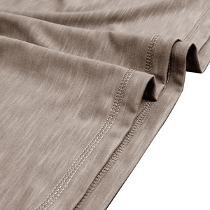 Macro shot of slub cotton fabric texture and double-needle stitching on men's Henley shirt