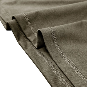 Macro view of olive green knit fabric with precise double-needle stitching on hem