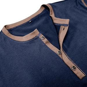 Detail of dark blue Henley t-shirt neckline with brown trim, buttons and M size tag