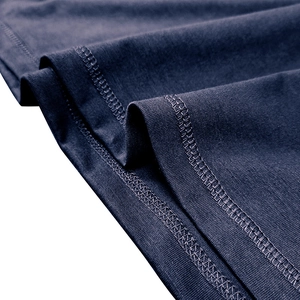 Detailed close-up of flat-seam stitching and knit texture on dark blue men's t-shirt