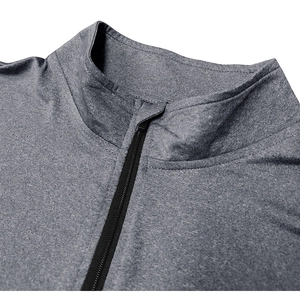Dettaglio della maglia sportiva grigia con cerniera, collo alto e tessuto elasticizzato