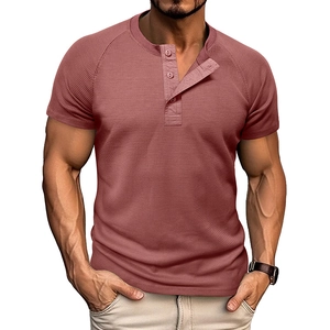 Detail of waffle knit fabric and classic three-button Henley collar on dusky pink t-shirt