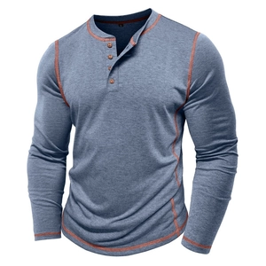 Detail of blue men's Henley shirt featuring four buttons and orange contrast stitching