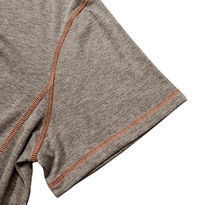 Men's short sleeve Henley shirt in dark grey knit fabric with orange contrast stitching detail