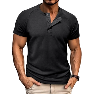 Detail of men's black waffle knit Henley shirt featuring raglan sleeves and three-button placket
