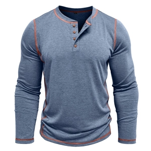 Detail of blue men's Henley shirt featuring orange contrast stitching and four wooden buttons