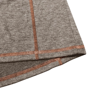 Macro shot of grey knit fabric with contrasting orange flatlock stitching detail