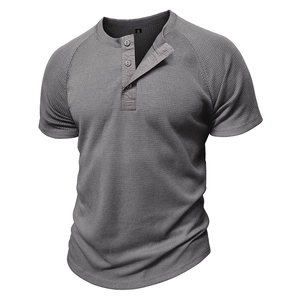 Close-up of grey waffle knit Henley shirt showing fabric texture and button neckline