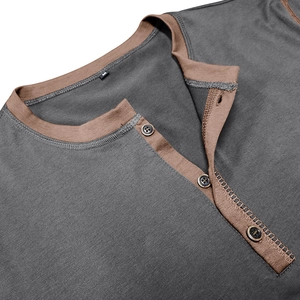 Detail of Henley neck with brown contrast trim and three buttons on gray cotton fabric