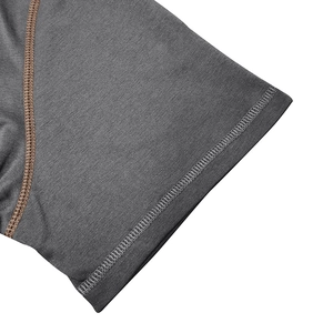 Macro shot of dark grey knit fabric with contrast brown stitching on the sleeve cuff