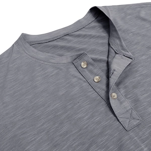 Macro shot of grey slub cotton Henley shirt showing three-button collar and fabric texture