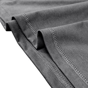 Detail macro shot of dark grey knit fabric with durable double-needle stitching quality