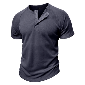 Close-up of waffle knit texture and three-button neckline on dark grey men's Henley shirt