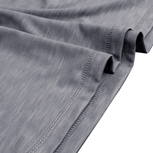 Macro detail of high-quality double-needle stitching on grey slub cotton Henley shirt