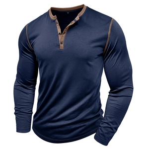 Detail view of the contrasting collar and button placket on a navy men's Henley shirt