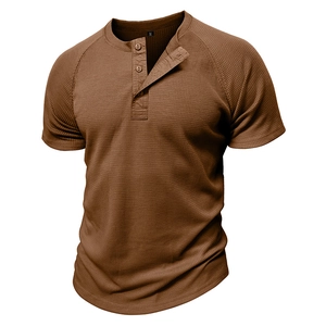Detail view of waffle knit texture on men's tan Henley shirt with three buttons