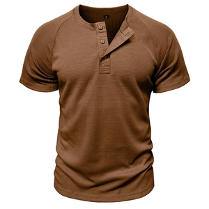 Macro shot of men's caramel waffle knit fabric and three-button henley collar detail