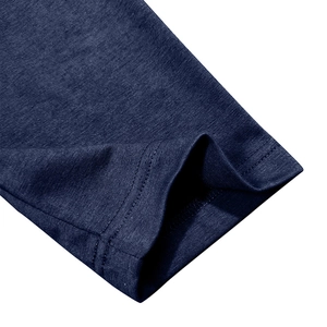 Detailed macro view of the navy blue knit fabric texture and double-stitched hem on the sleeve