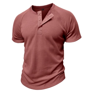 Detail of waffle knit fabric and three-button neckline on brick red men's Henley shirt