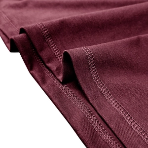 Detail view of the burgundy fabric showing double-row flat seam edging on the T-shirt hem