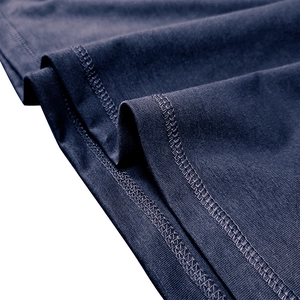 Detail view of high-quality navy blue knitted fabric with precision double stitching