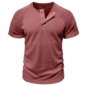 Detail of waffle knit fabric and three-button placket on men's brick red Henley shirt