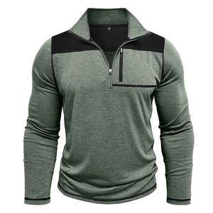 Detail of green knit pullover with high collar zipper and black contrast chest pocket