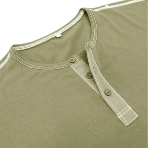 Detail of Henley neck with three buttons and white contrast stitching on olive green fabric