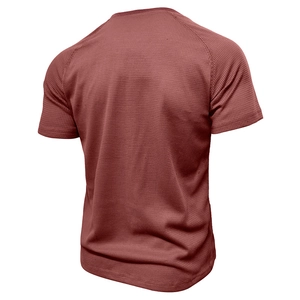 Macro detail of men's dark red waffle knit Henley shirt with breathable mesh texture