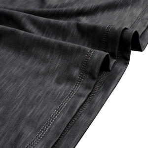 Macro shot of charcoal grey slub cotton fabric with double-needle hem stitching detail