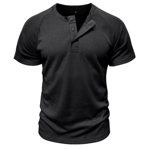 Detail of black waffle knit fabric and three-button neckline on a men's Henley shirt