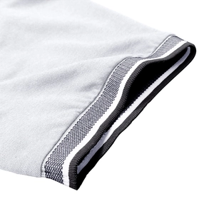 Detailed macro shot of grey piqué polo shirt fabric with striped ribbed cuff detail