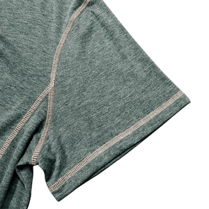 Detailed close-up of flatlock stitching and knit texture on grey short-sleeve Henley shirt