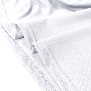 Detailed macro view of white piqué cotton fabric with fine double-needle hem stitching