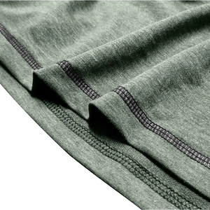 Detail of dark green knit fabric showing double needle stitching and premium texture