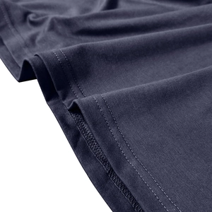 Macro detail of navy blue knit polo shirt featuring reinforced double-needle stitching