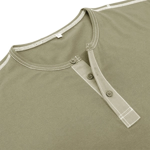 Macro shot of olive green Henley shirt collar with three buttons and contrast stitching