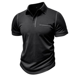 Détail d'un polo noir avec des coutures contrastées grises et une poche poitrine