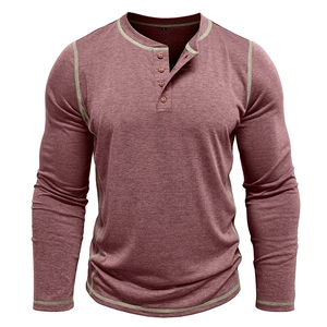 Detail of vintage red men's Henley shirt showing four-button placket and green contrast stitching